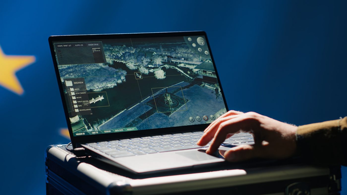 Analyst working with GIS software on a laptop
